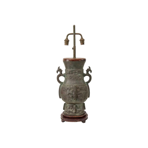 487 - A Chinese Archaic style bronze table lamp. Height 60cm.