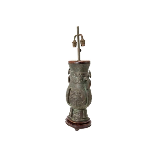 487 - A Chinese Archaic style bronze table lamp. Height 60cm.