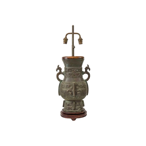 487 - A Chinese Archaic style bronze table lamp. Height 60cm.