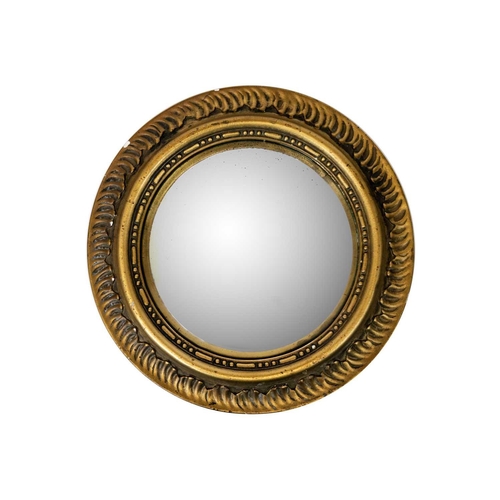 494 - A Circular gilt plaster convex wall mirror. Mid 20th century, diameter 36.5cm.