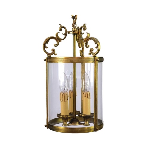 499 - A pair of circular glazed brass hall lanterns. 20th century, each with triple light fittings and C s... 