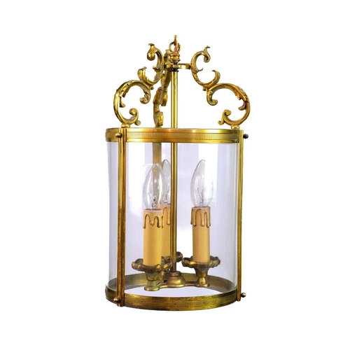 499 - A pair of circular glazed brass hall lanterns. 20th century, each with triple light fittings and C s... 