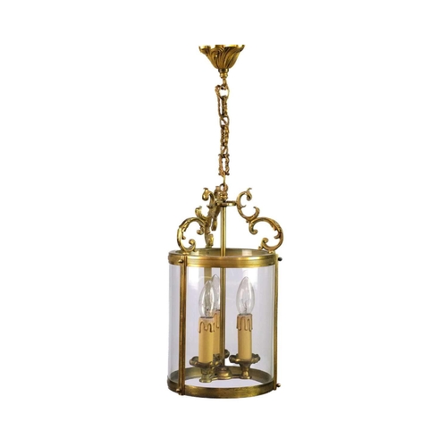 499 - A pair of circular glazed brass hall lanterns. 20th century, each with triple light fittings and C s... 