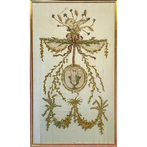 500 - A late George III silk work panel. With a central urn medallion hung from a ribbon with floral festo... 