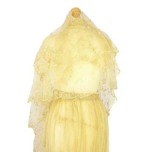 521 - A late 19th century lace petticoat. Together with a lace shawl matching veil and a pair of lace fing... 