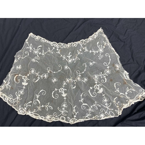 521 - A late 19th century lace petticoat. Together with a lace shawl matching veil and a pair of lace fing... 