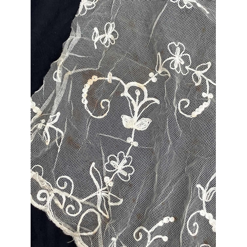 521 - A late 19th century lace petticoat. Together with a lace shawl matching veil and a pair of lace fing... 