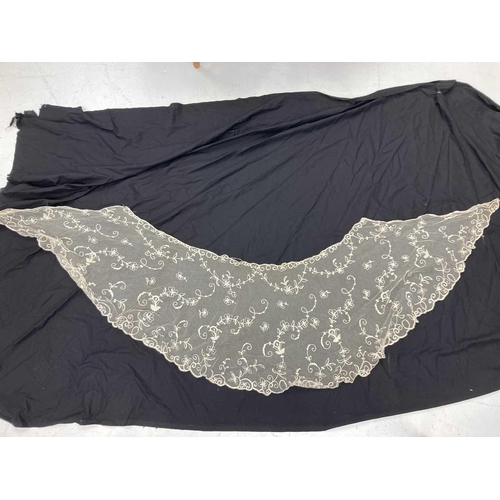 521 - A late 19th century lace petticoat. Together with a lace shawl matching veil and a pair of lace fing... 