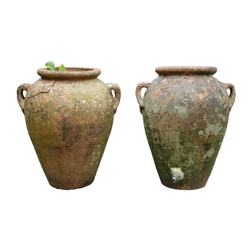 533 - A pair of terracotta twin handled olive jars. One with tap. Height 51cm.