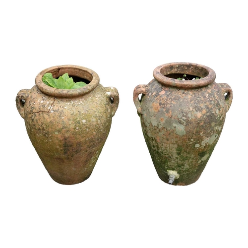 533 - A pair of terracotta twin handled olive jars. One with tap. Height 51cm.