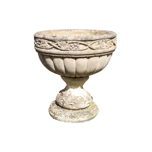 534 - A composition stone urn shape garden planter with fruiting vine decoration. Height 48cm, diameter 45... 