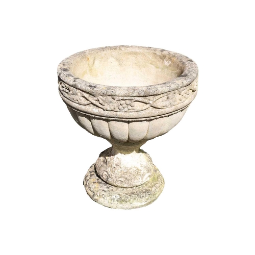 534 - A composition stone urn shape garden planter with fruiting vine decoration. Height 48cm, diameter 45... 