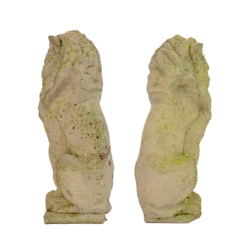 536 - Two reconstituted stone figures of seated lions. Height 34cm.