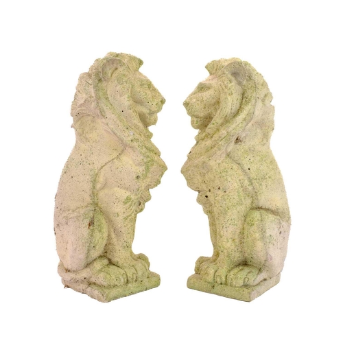 536 - Two reconstituted stone figures of seated lions. Height 34cm.