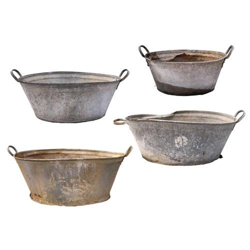 537 - Four galvanised tin baths. The largest 33cm high, 87cm wide, and 57.5cm deep.