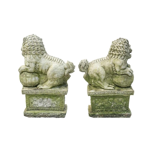 544 - A pair of reconstituted stone Chinese lion dog garden ornaments. Height 51cm.