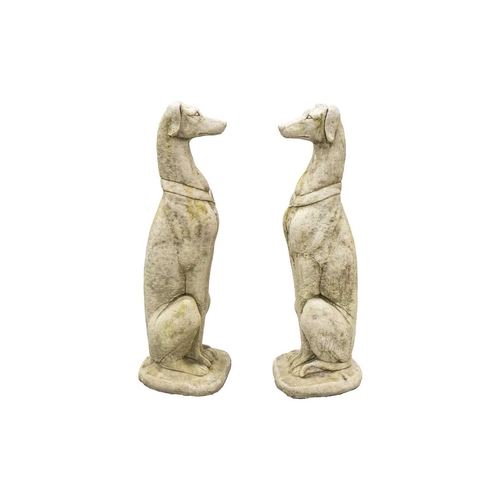 548 - A pair of large reconstituted stone seated whippet garden ornaments. Height 84cm.