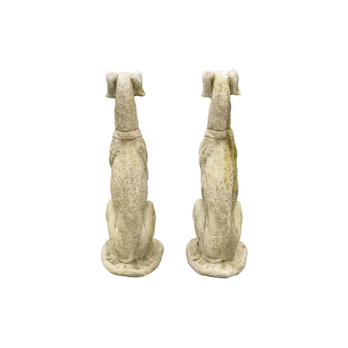 548 - A pair of large reconstituted stone seated whippet garden ornaments. Height 84cm.