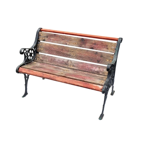 549 - A cast metal and slatted wood two seat garden bench. Height 71cm, width 105cm, depth 55cm.