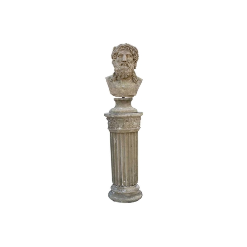 561 - A reconstituted stone sculpture of a male head, raised on fluted column. Height 121cm.