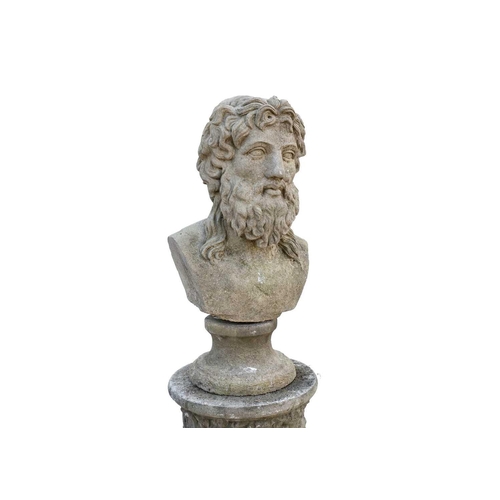 561 - A reconstituted stone sculpture of a male head, raised on fluted column. Height 121cm.