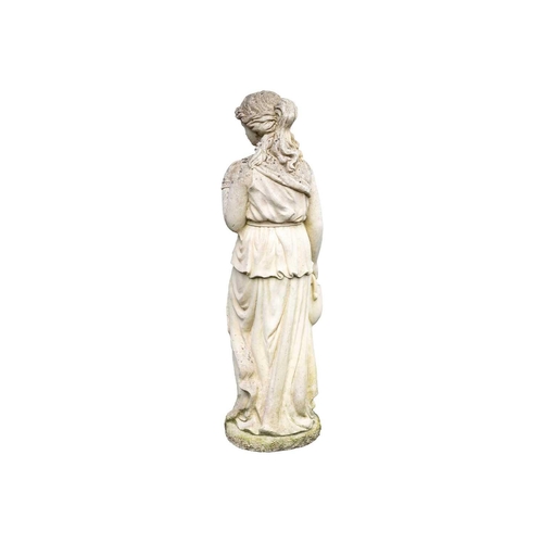 562 - A reconstituted stone garden statue modelled as a classical female holding a vase. Height 110cm.