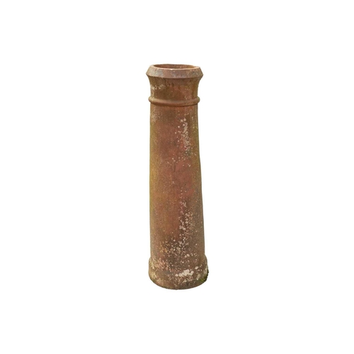 563 - A tall terracotta chimney pot. Height 110cm.