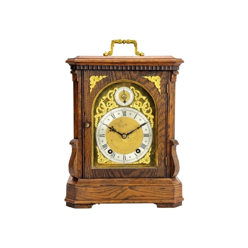 567 - A German Winterhalder and Hofmeier oak cased chiming bracket clock. The gilt mask with applied gilt ... 