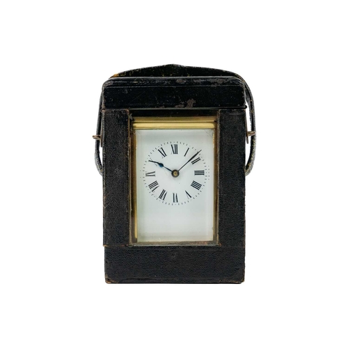 569 - A French brass cased carriage timepiece. With folding handle, contained in a carriage case, height 1... 