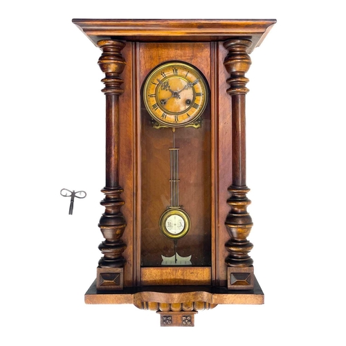 576 - A German Kienzle walnut cased wall clock. Striking on a coiled gong, height 68cm.