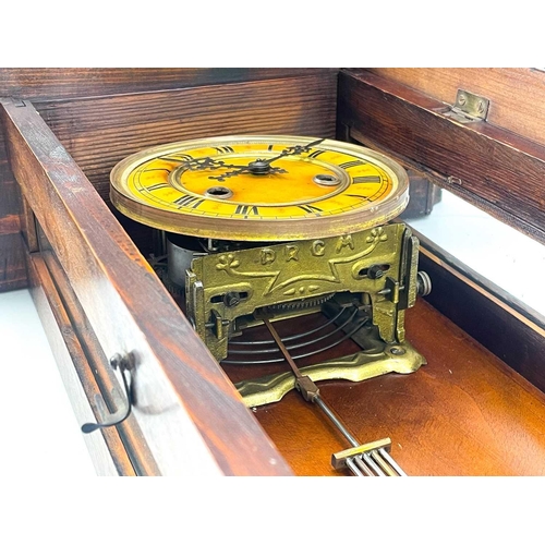 576 - A German Kienzle walnut cased wall clock. Striking on a coiled gong, height 68cm.