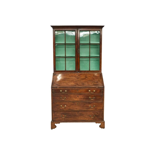 579 - A George III mahogany bureau bookcase. The upper section with twin glazed doors enclosing three shel... 