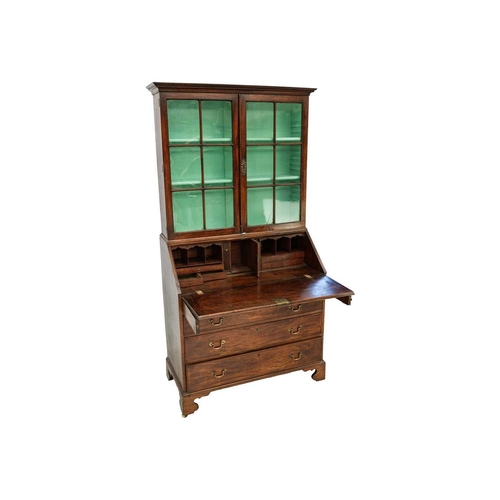 579 - A George III mahogany bureau bookcase. The upper section with twin glazed doors enclosing three shel... 