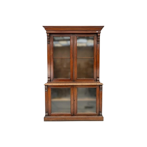 586 - A Victorian mahogany bookcase cabinet. The upper part with two glazed doors enclosing glass shelves,... 