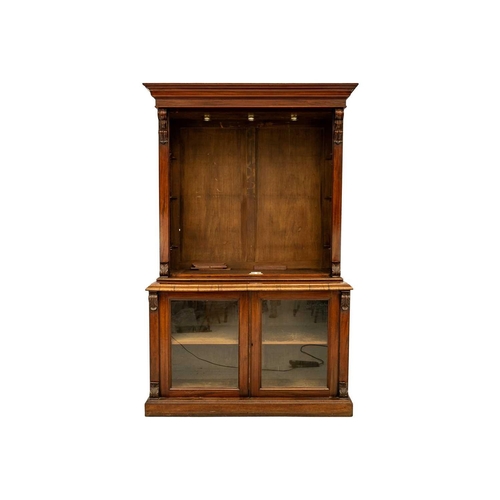 586 - A Victorian mahogany bookcase cabinet. The upper part with two glazed doors enclosing glass shelves,... 