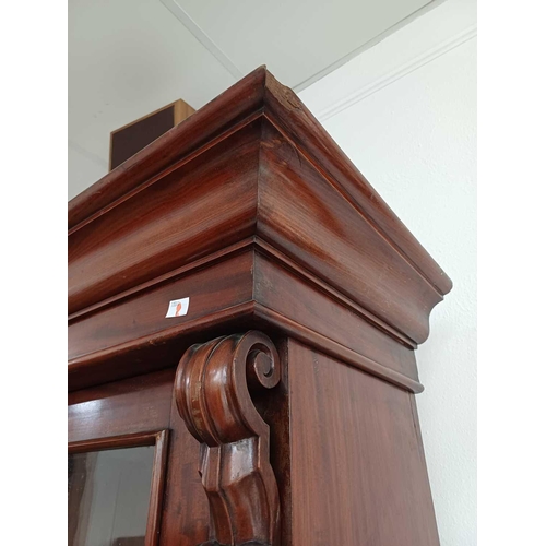 586 - A Victorian mahogany bookcase cabinet. The upper part with two glazed doors enclosing glass shelves,... 