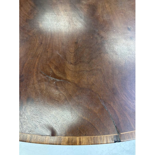 591 - A George III mahogany and kingwood banded oval Pembroke table. With an end drawer, and raised on squ... 