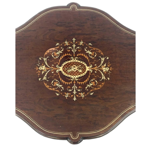 596 - A mid century Italian walnut quatrefoil centre table with bone and fruitwood inlay. With lower stret... 