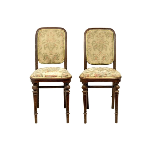 597 - A pair of early 20th century Thonet bentwood chairs. Both with paper labels, on turned supports. (2)