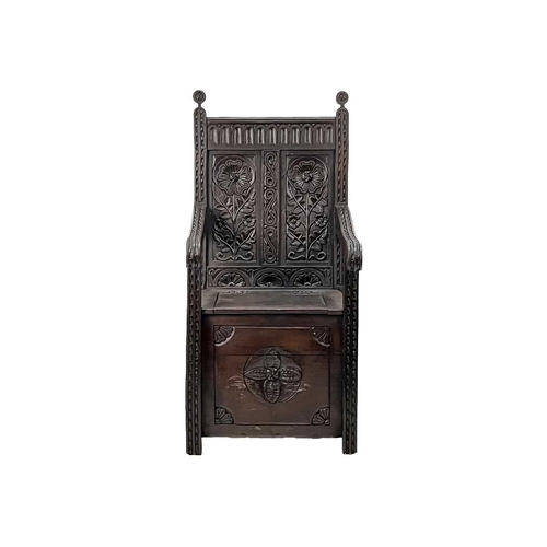 598 - An oak wainscot armchair. Early 20th century, the two back panels carved with stylised flowers, the ... 