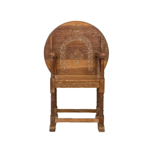 600 - A 20th century limed oak monk's bench. With carved circular hinged top, height 105cm.