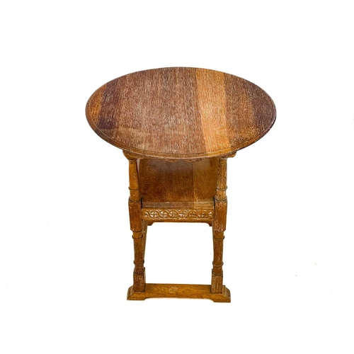 600 - A 20th century limed oak monk's bench. With carved circular hinged top, height 105cm.