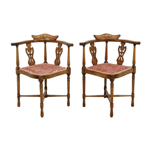 603 - A pair of Edwardian mahogany and inlaid corner chairs. With pierced vase splats and padded seats, on... 