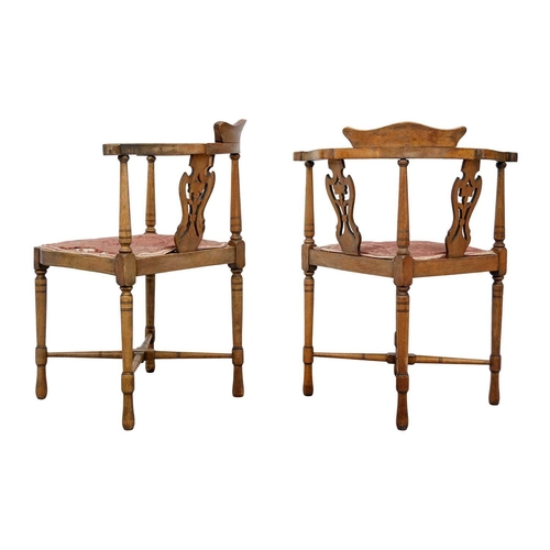 603 - A pair of Edwardian mahogany and inlaid corner chairs. With pierced vase splats and padded seats, on... 