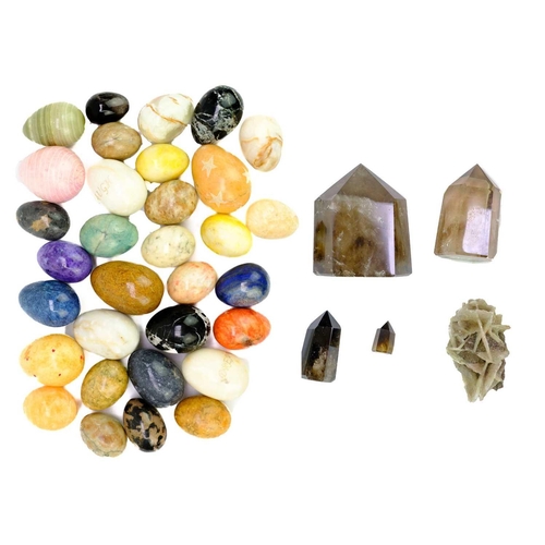 61 - A collection of egg-shaped minerals. To include; zebra jasper, lapis lazuli, onyx, orange calcite, e... 