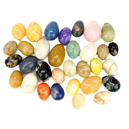 61 - A collection of egg-shaped minerals. To include; zebra jasper, lapis lazuli, onyx, orange calcite, e... 