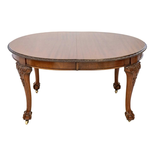 616 - A Victorian mahogany extending dining table. With D ends on ball and claw feet and castor wheels, tw... 