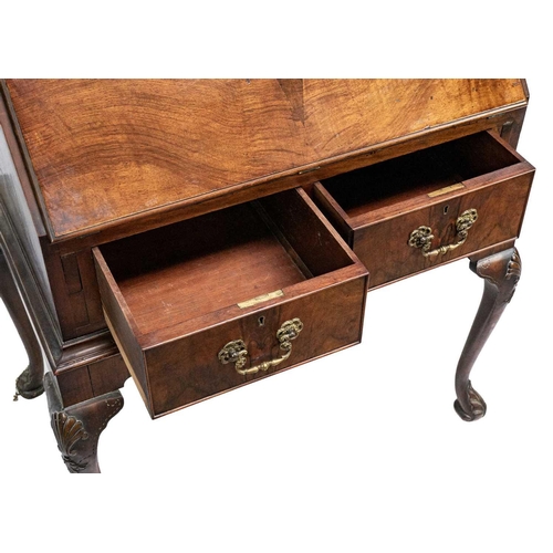 635 - An early 20th Century walnut bureau. Sloped full front revealing an arrangement of drawers and pigeo... 