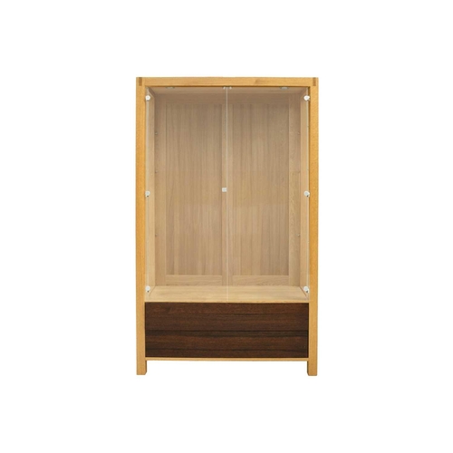 641 - A large modern oak bespoke glazed display cabinet. With three adjustable glass shelves above two dra... 