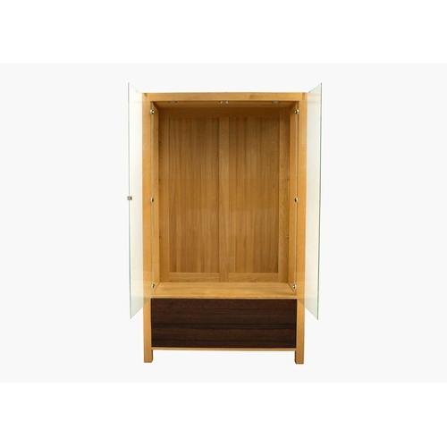 641 - A large modern oak bespoke glazed display cabinet. With three adjustable glass shelves above two dra... 